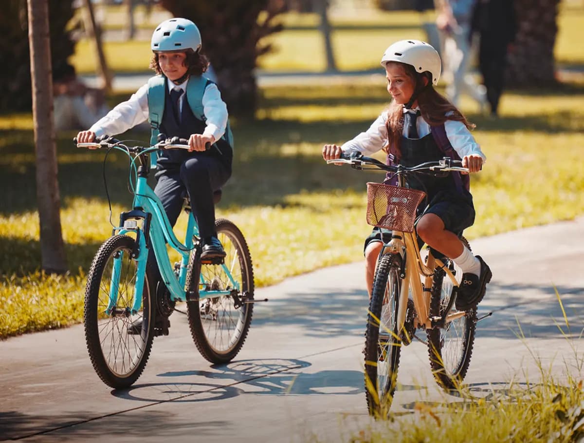 Developer rendering of children cycling on a shaded community path