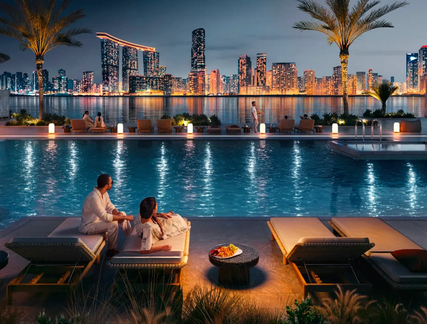 Developer rendering of an evening waterfront pool terrace with the Abu Dhabi skyline across the water