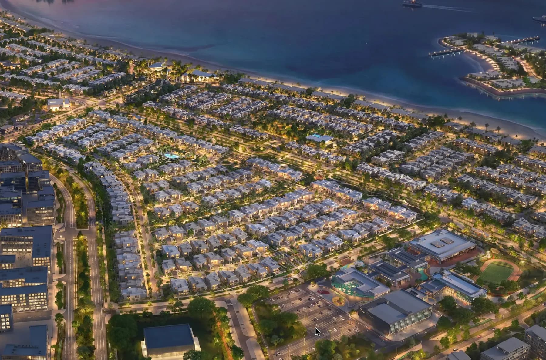 Developer rendering of the Talay community at dusk, villas lit along the green spine with the beach and sea beyond